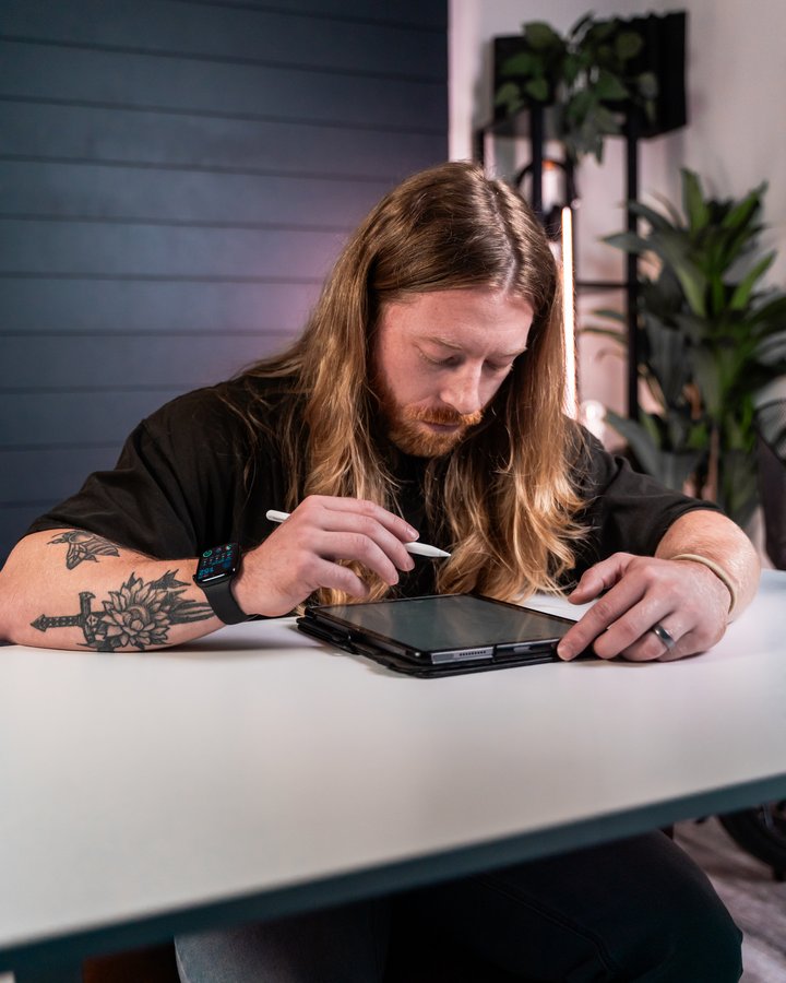 Keagan Barnes reviewing client labs on a tablet